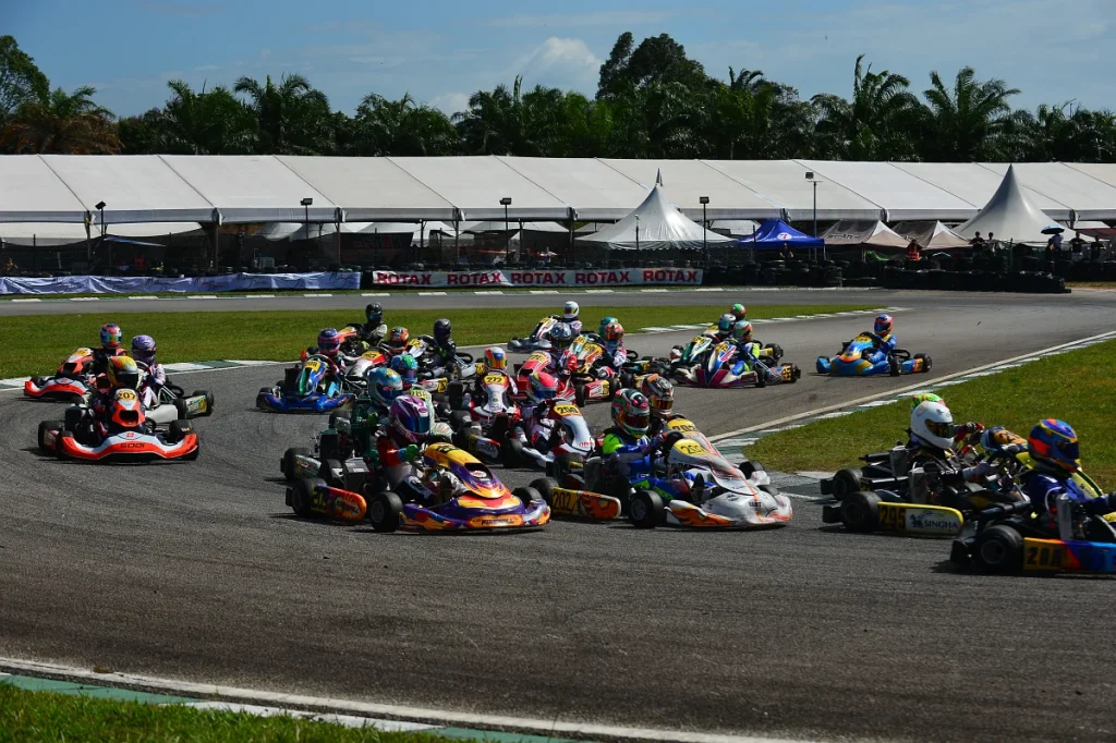 Junior karts going through Sepang karting circuit turn 2, big grid.