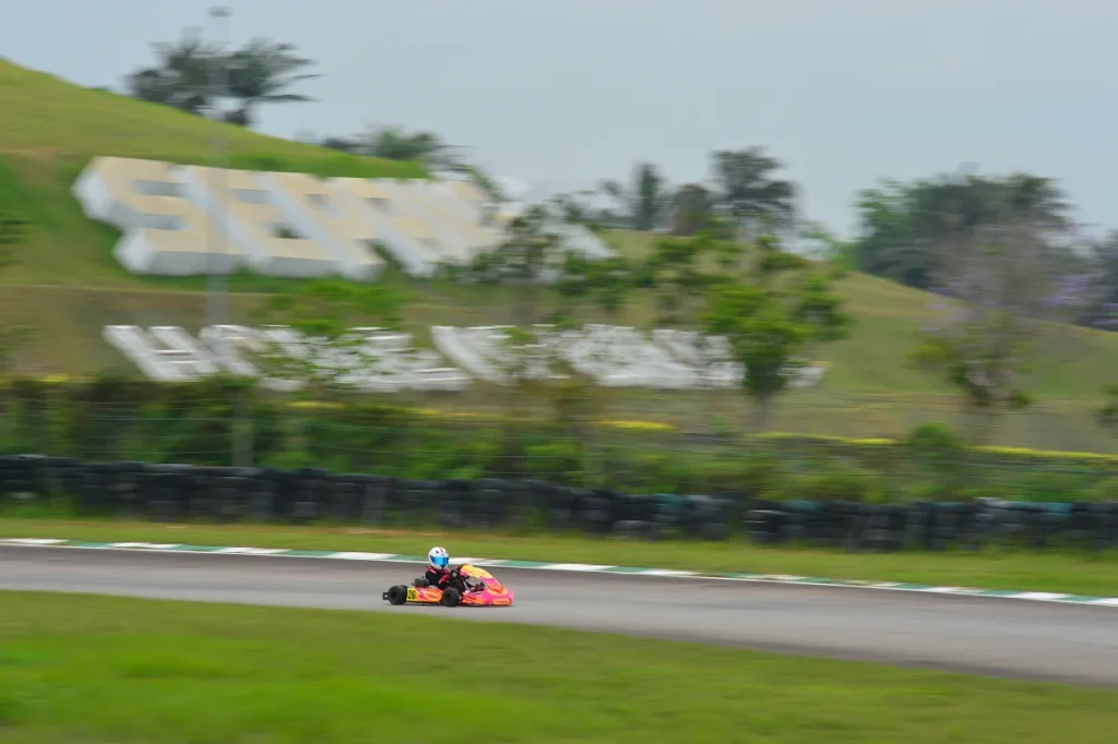 Sepang Karting Circuit Turn 5 with the old Sepang Circuit Home of Malaysian Motorsports signage in the background.
